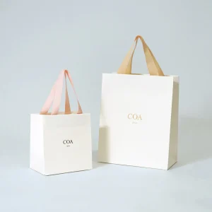 上品で軽やかなハンドルカラーが際立つ。COA GINZA様のブランドの統一感を表現したオリジナル紙袋